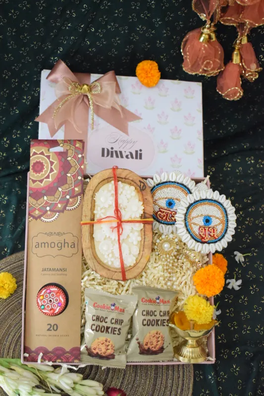Festive Diwali tray with a greeting, incense and sweet treats