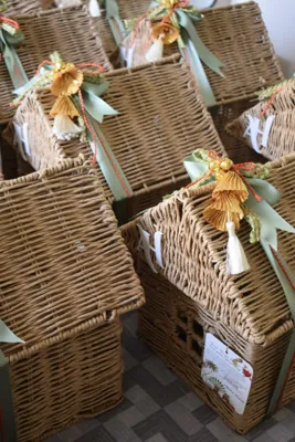 Tall woven baskets finished with pale green ribbons and gold tassels